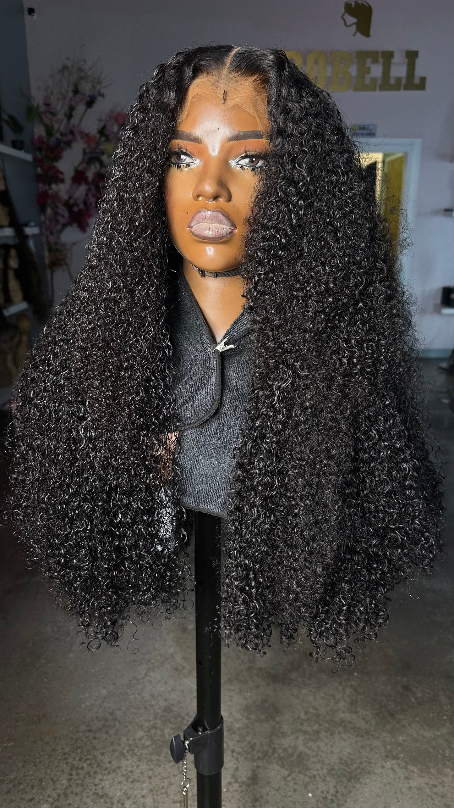 Pixie curl wig in a natural color made with 3 bundles and an HD lace closure 5X5; front quarter view.