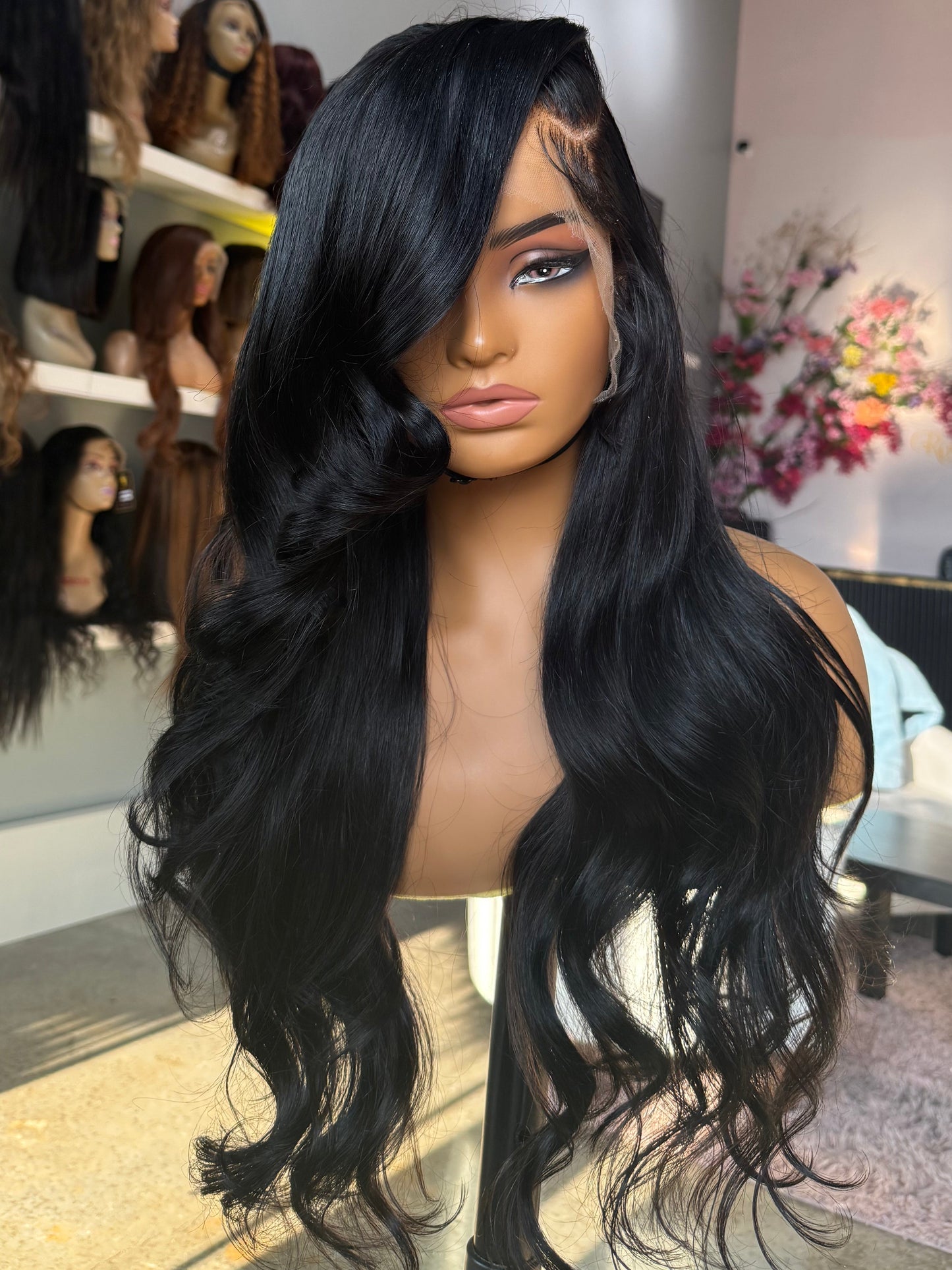Extra dense wig with a body wave texture, natural color, and left side part; front view version two.