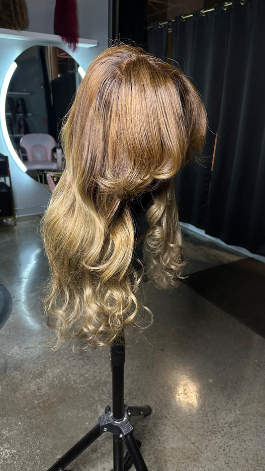 Human hair wig with brown roots and a light blonde color; right side view.