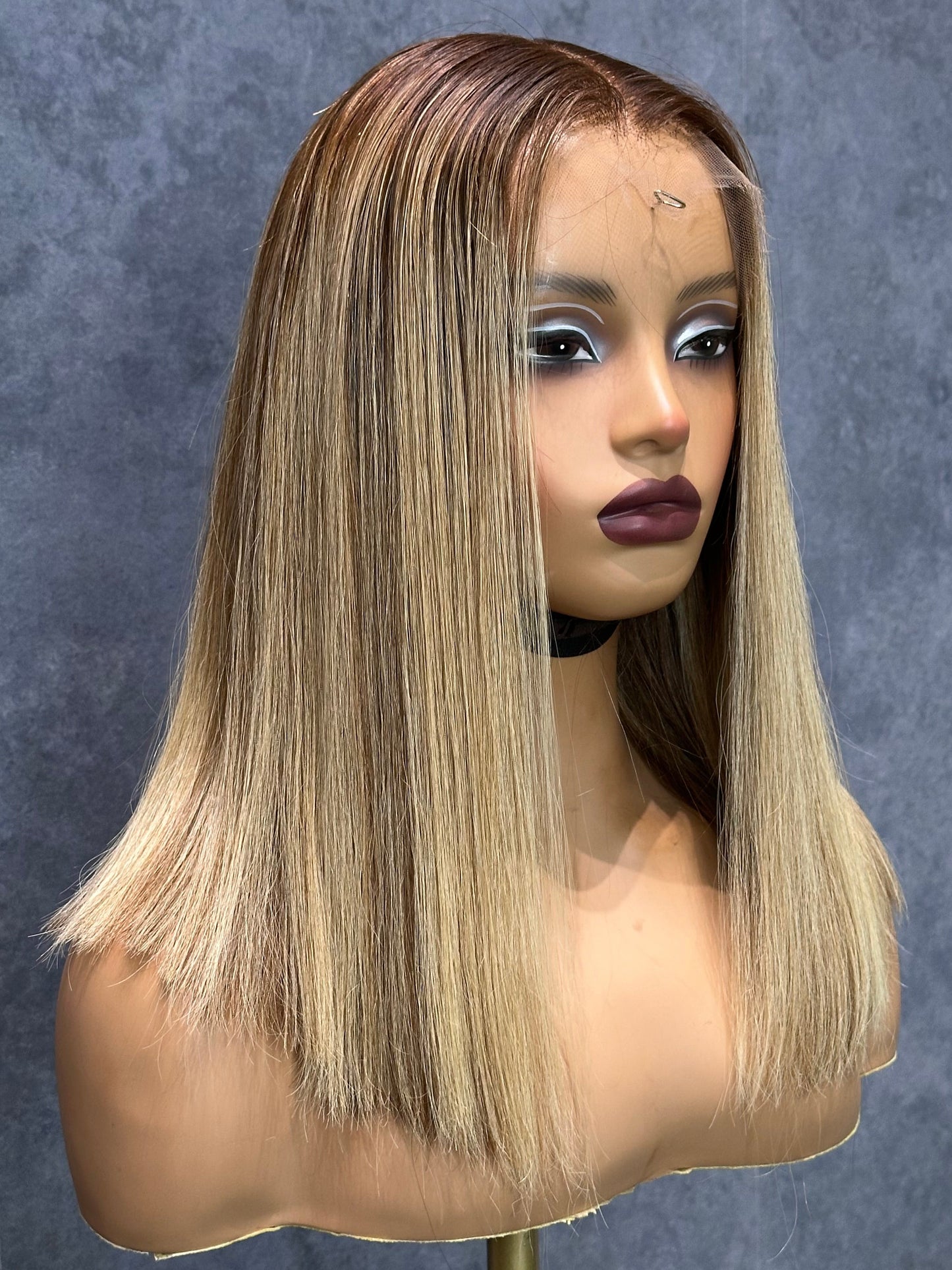 Front-left view of 2 bundle bob wig with brown roots.