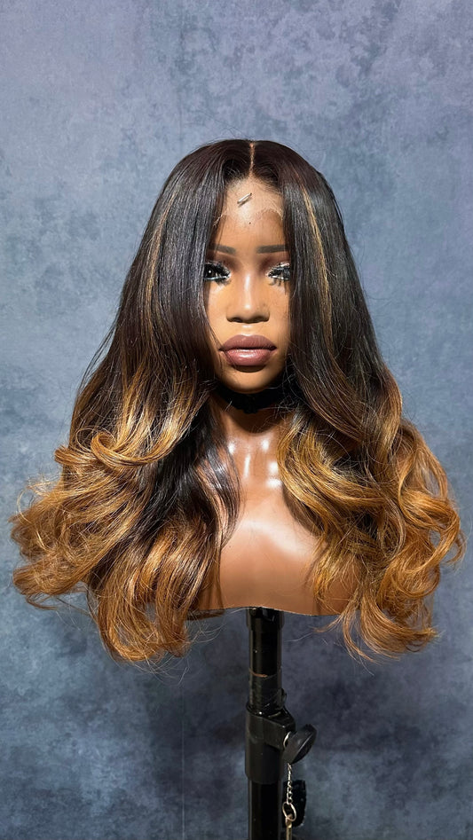 Virgin hair wig with brown highlights.