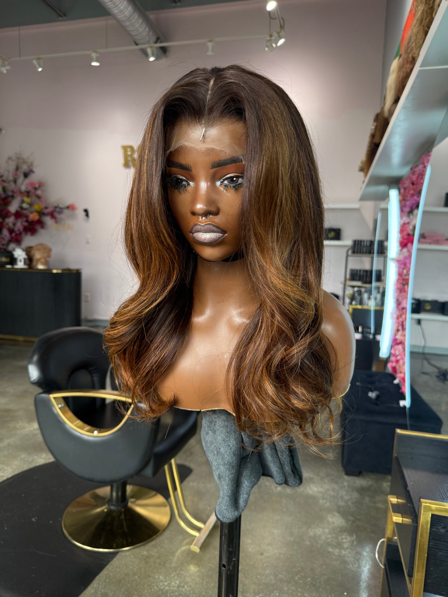 Mixed brown wig with highlights; front quarter view.