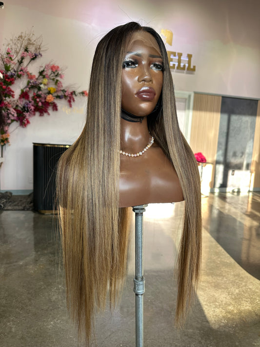 Mannequin head with long blonde hair in a salon setting