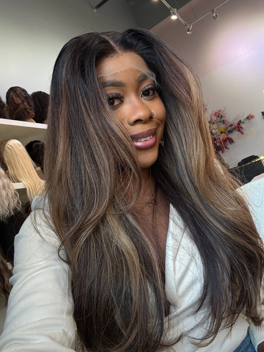Woman wearing raw hair wig showing the brown highlight colors and length.