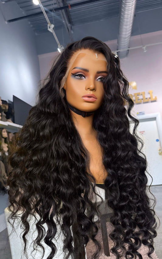 Long black wig with a loose wave texture.