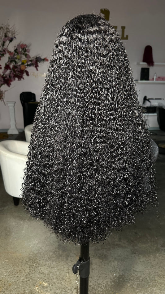 Pixie curl wig in a natural color made with 3 bundles and an HD lace closure 5X5; rear view.