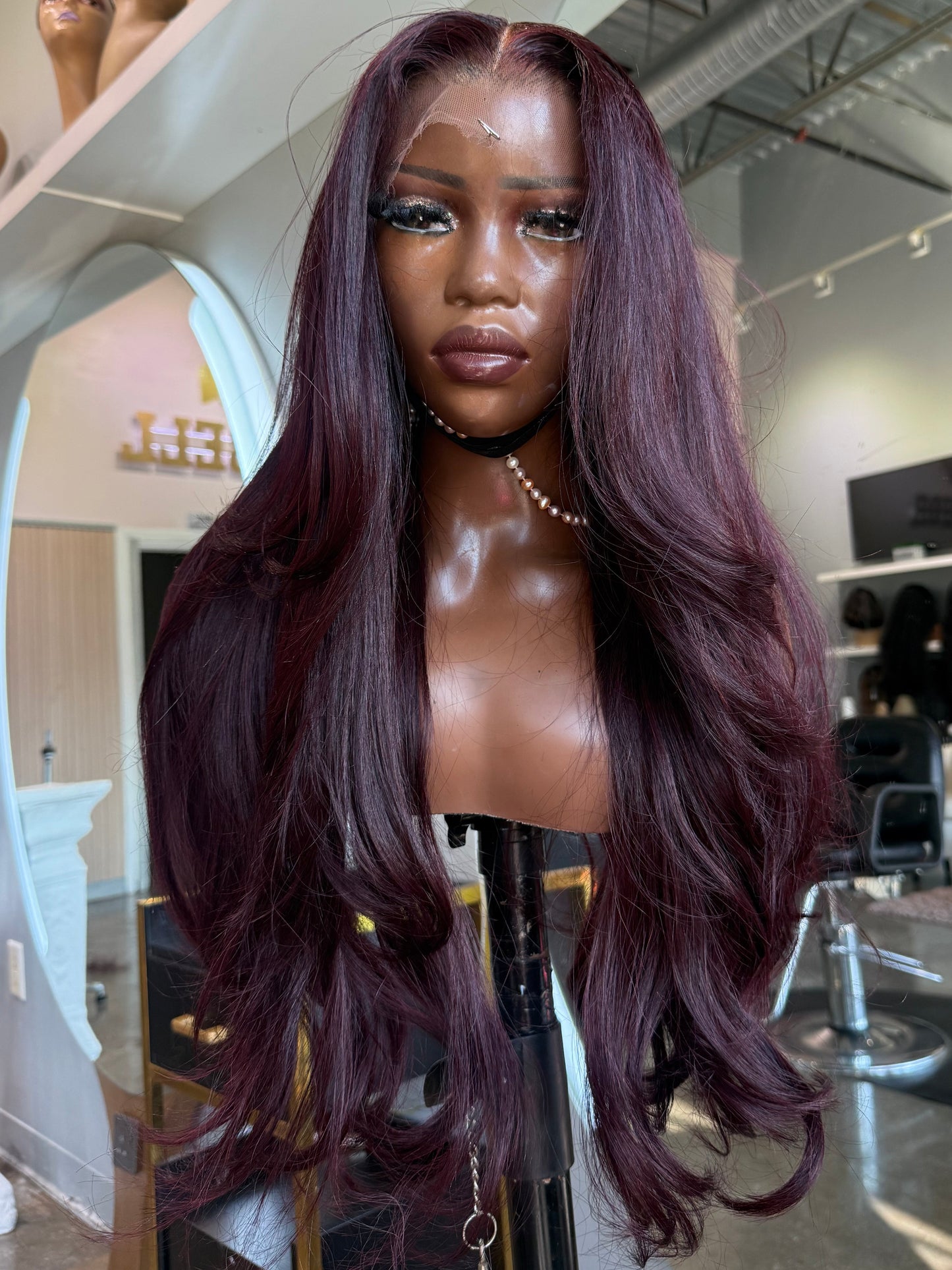 Front left view of dark burgundy wig made with a lace closure.