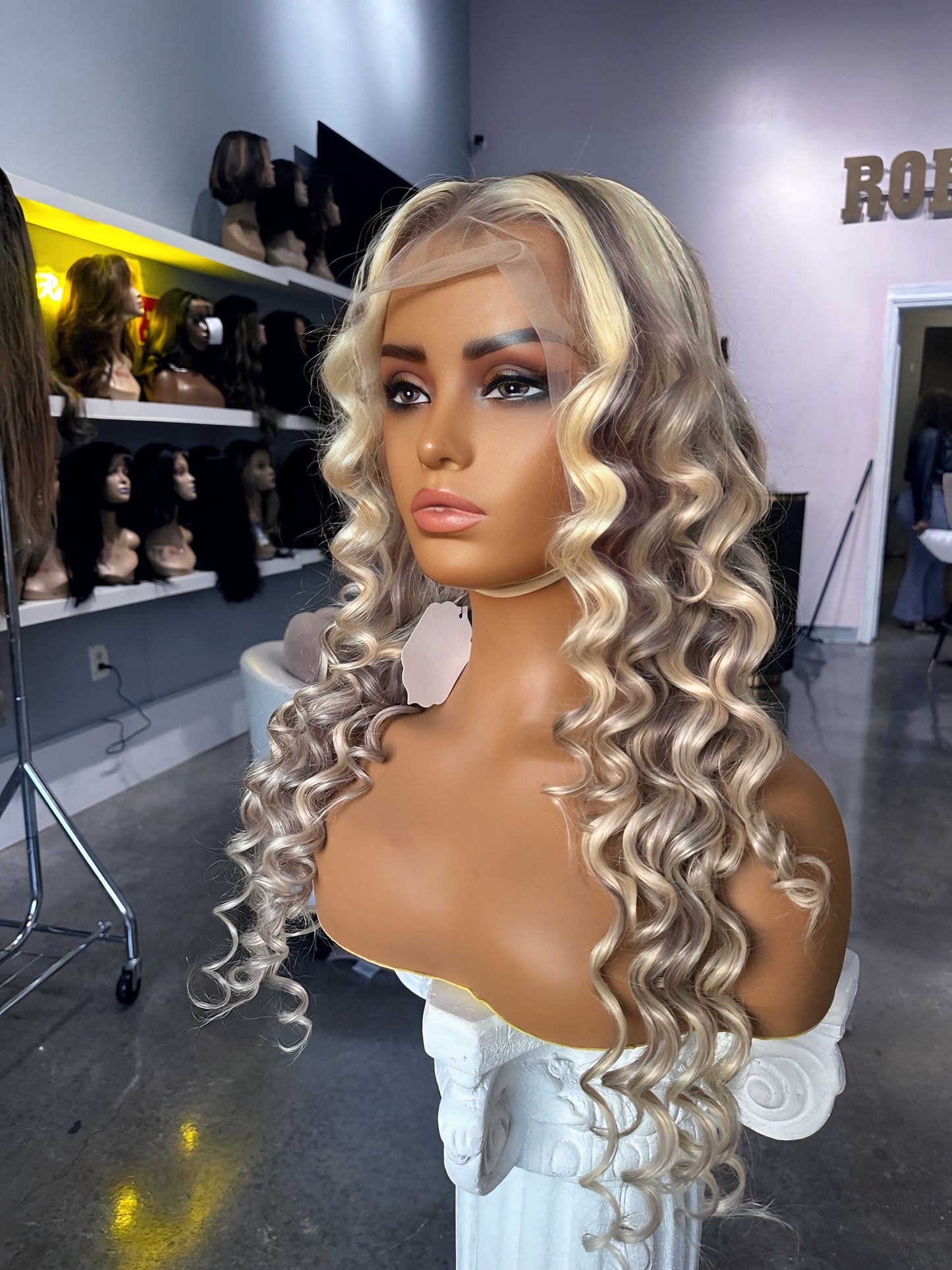 Blonde color wig with grey highlights; front right view.