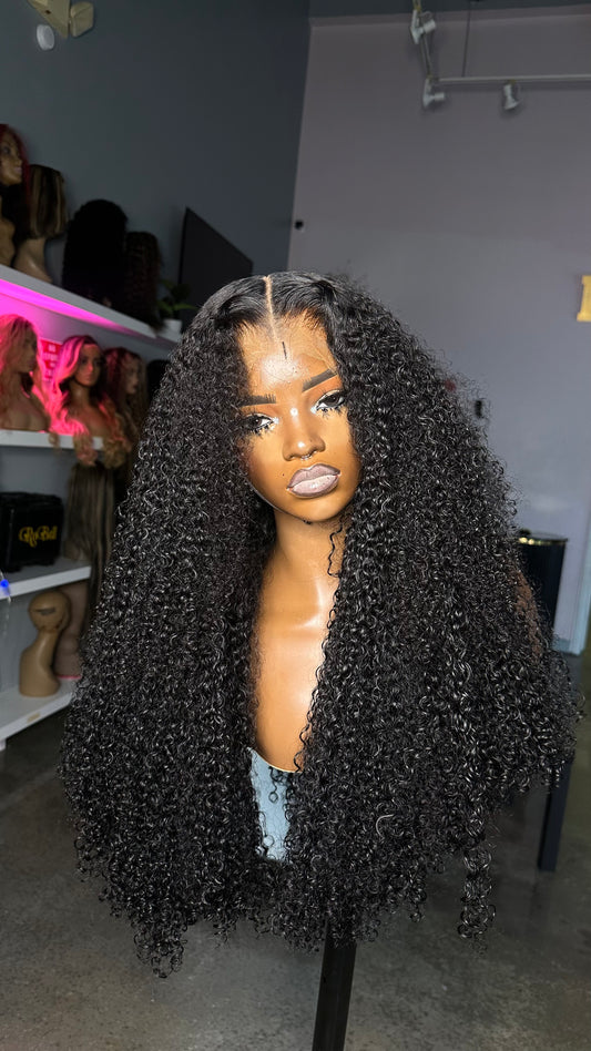 Pixie curl wig in a natural color made with 3 bundles and an HD lace closure 5X5; front view.