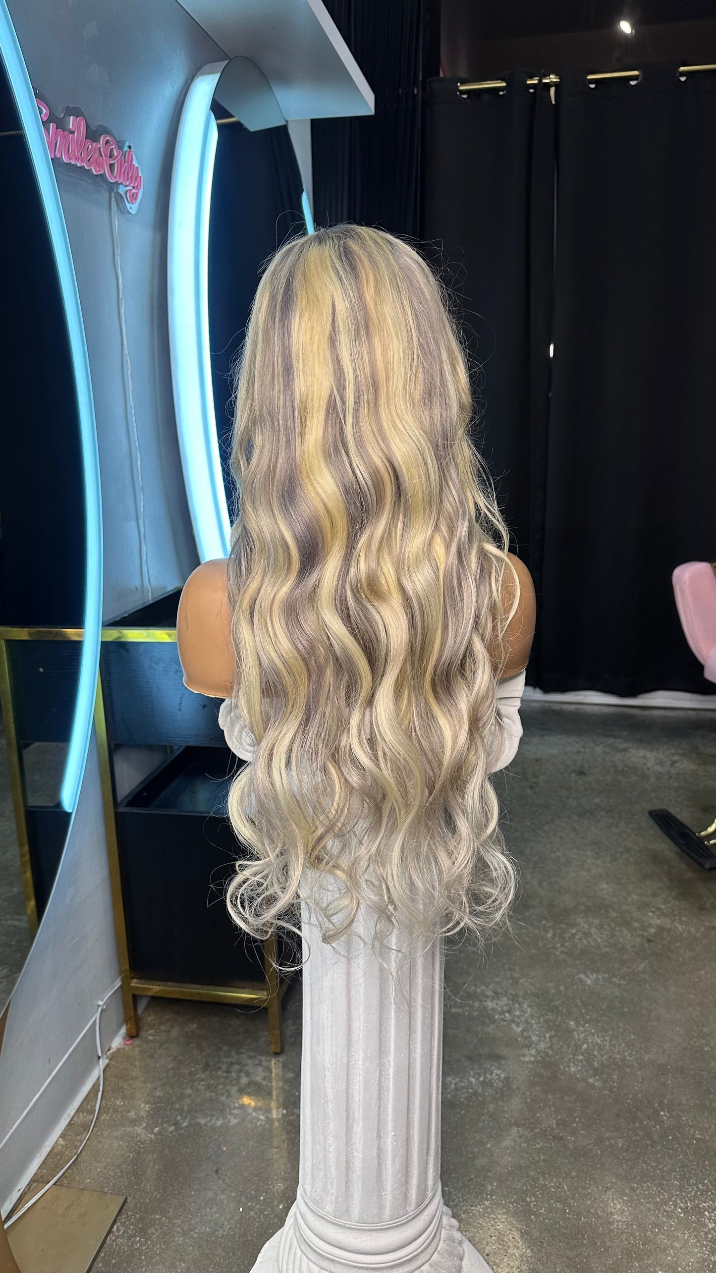 Blonde color wig with grey highlights; rear view.