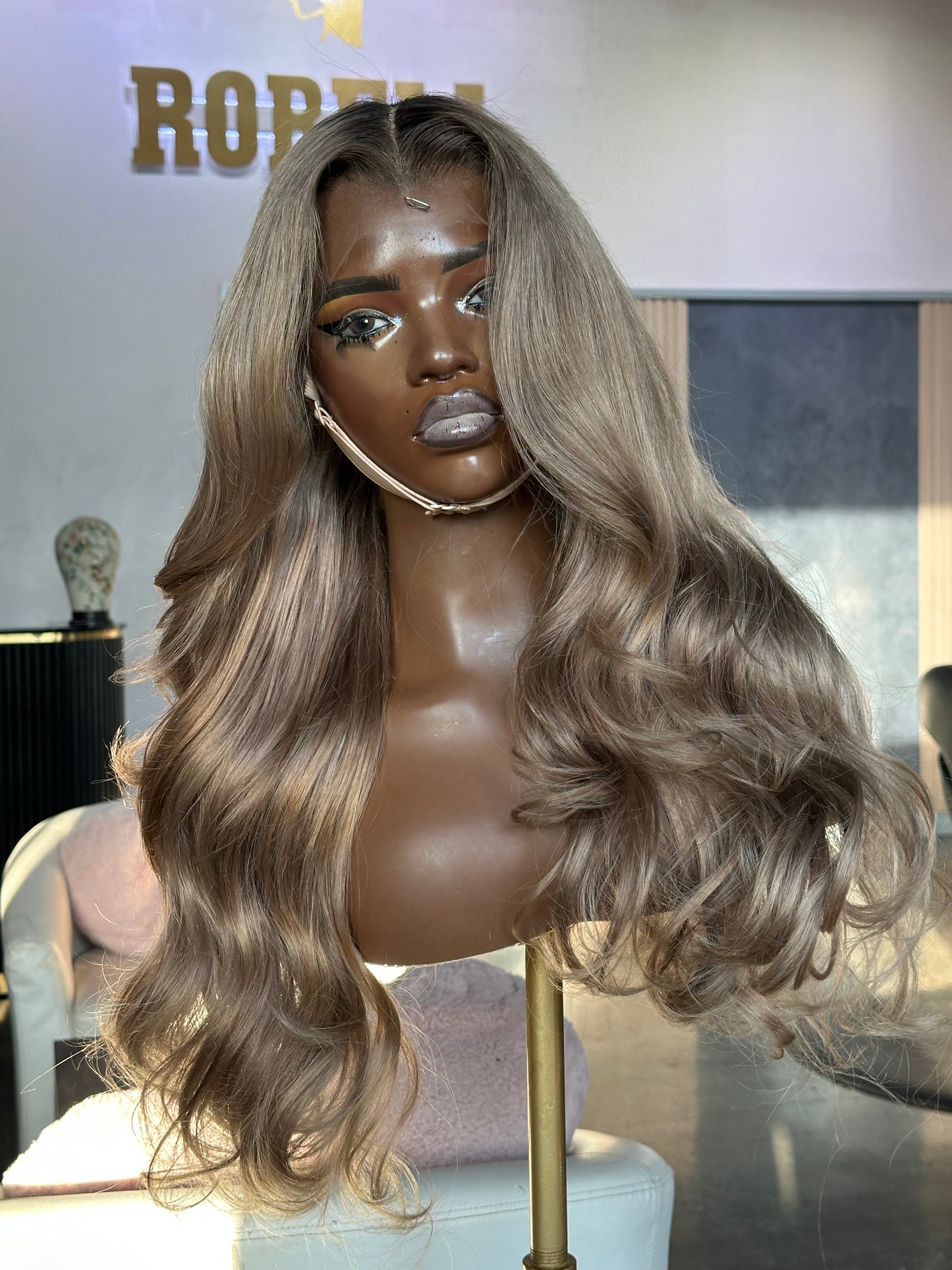 Mannequin head with a blonde wig on a blurred background