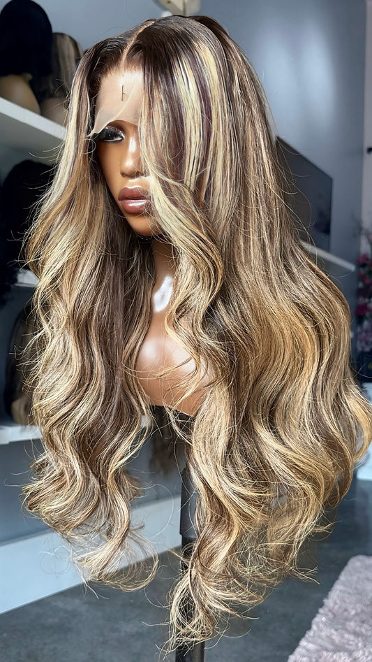 Long blonde wig with dark highlights.