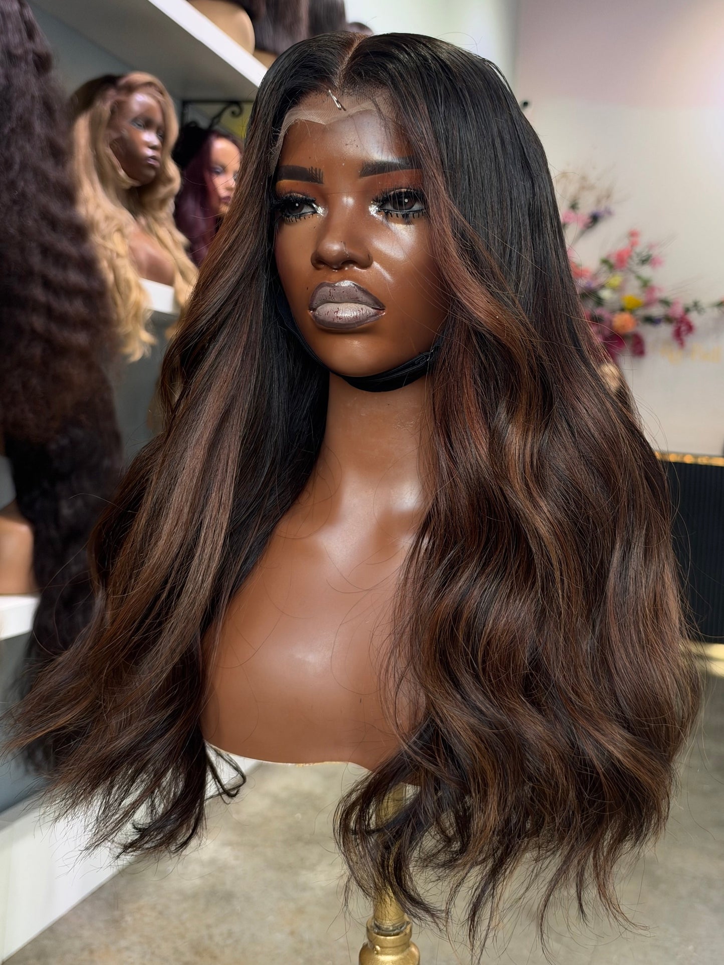 A body wave wig made with 3 bundles and custom chocolate and brown highlights.