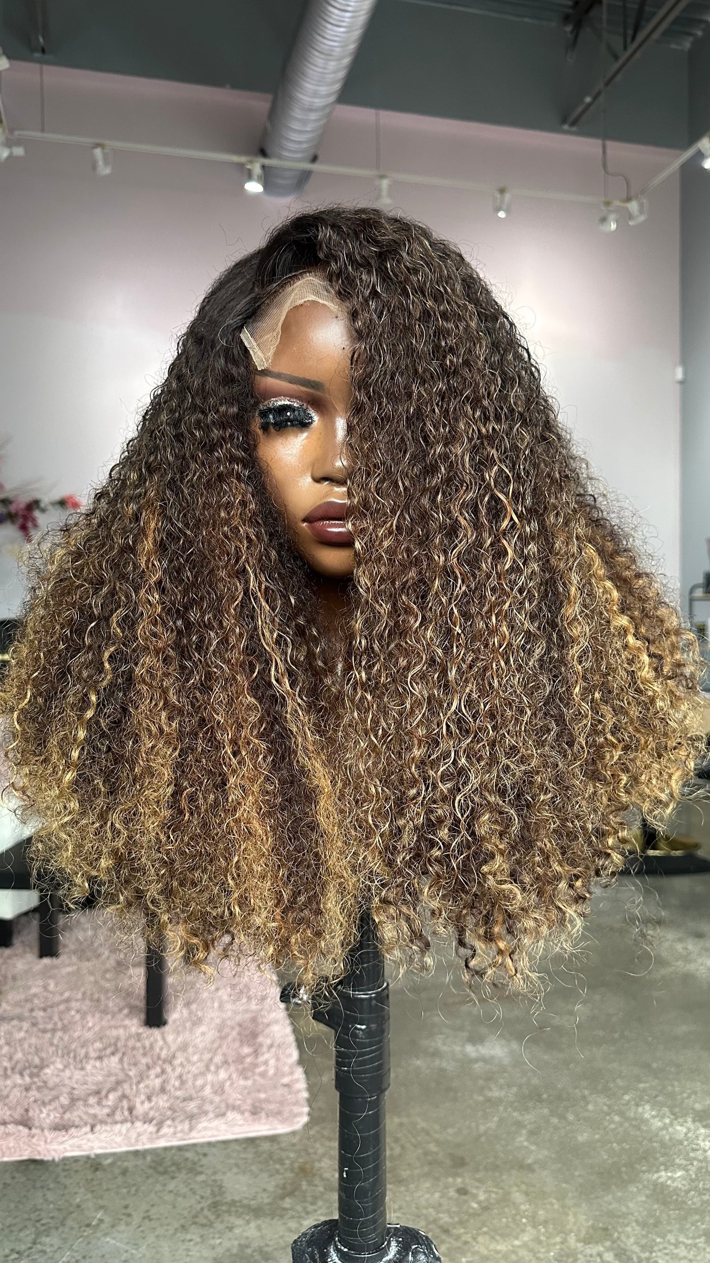 Pixie curl wig with highlights.