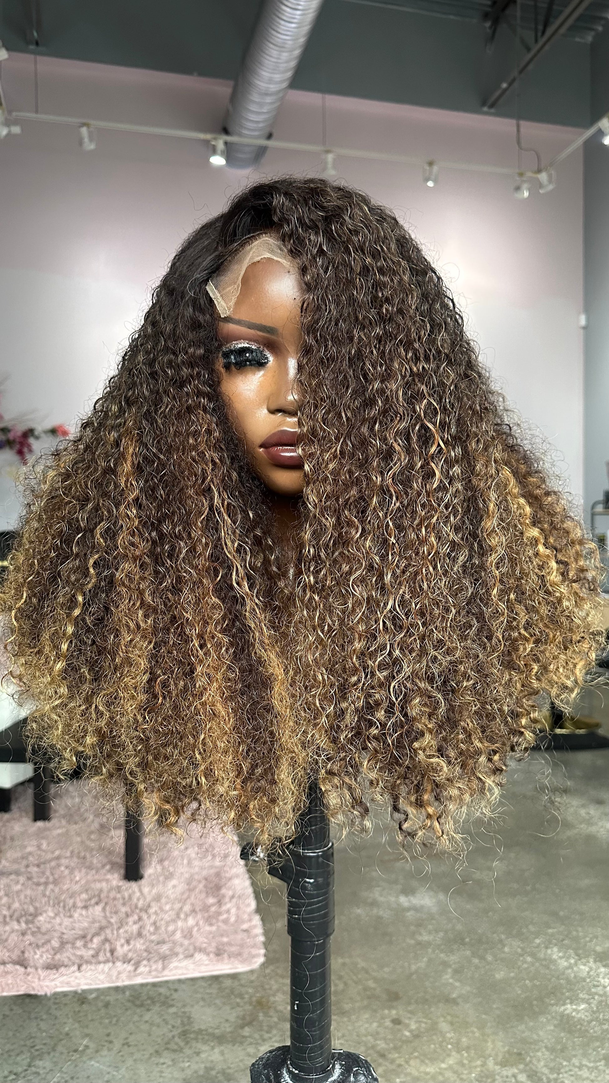 Pixie curl wig with highlights.