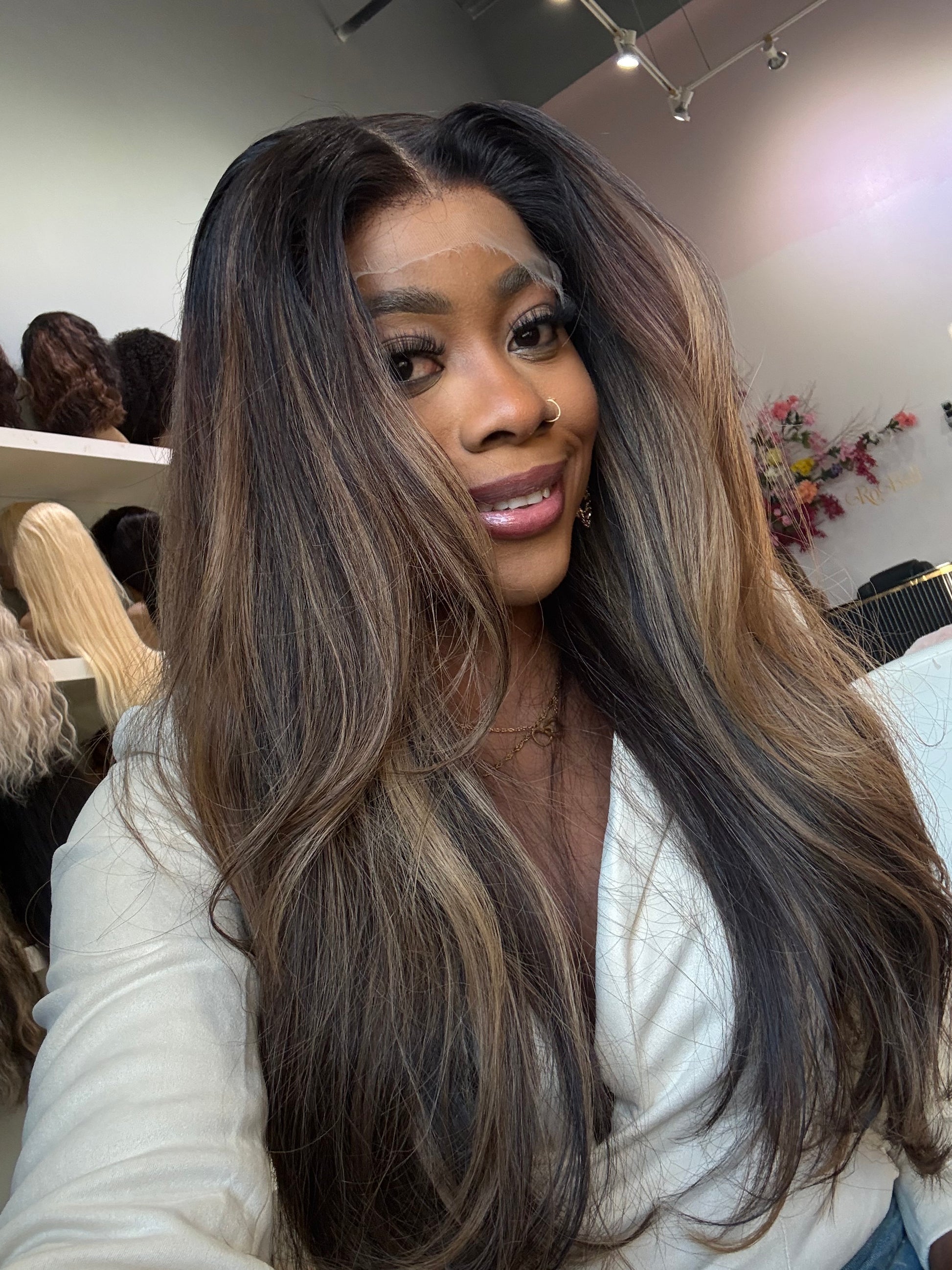 Woman wearing raw hair wig showing the brown highlight colors and length.