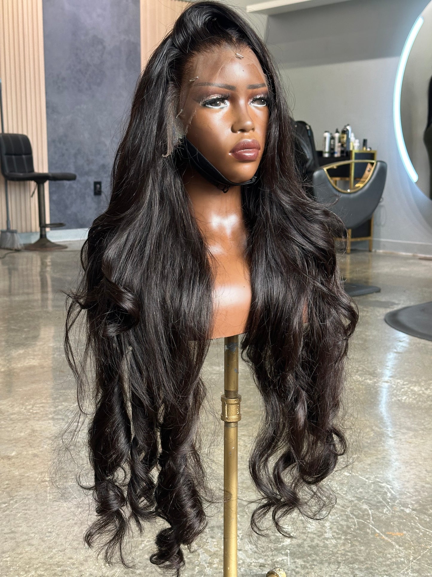 Left side view of lace frontal wig made with human hair in a natural black color. 
