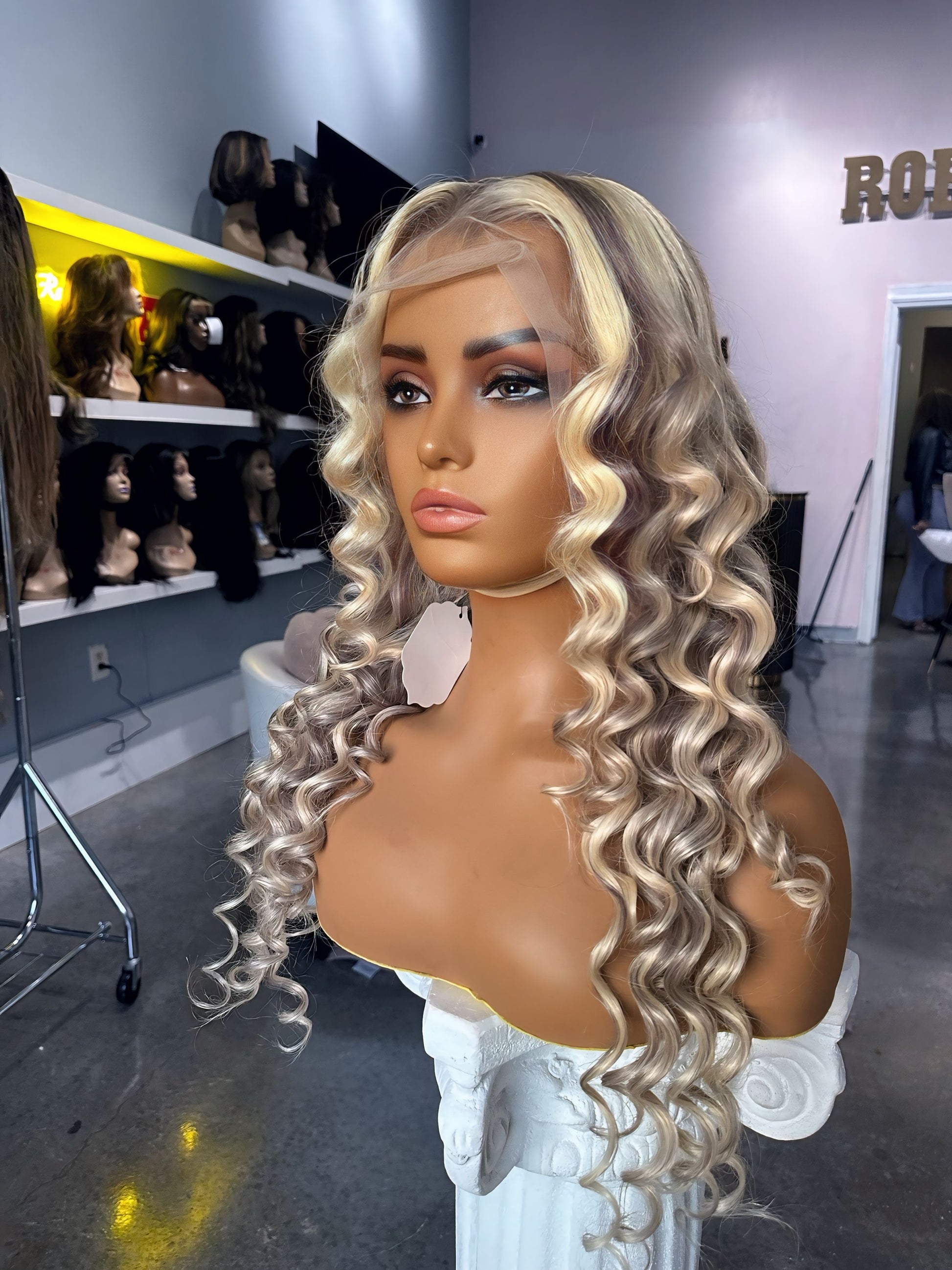 Blonde color wig with grey highlights; front right view.